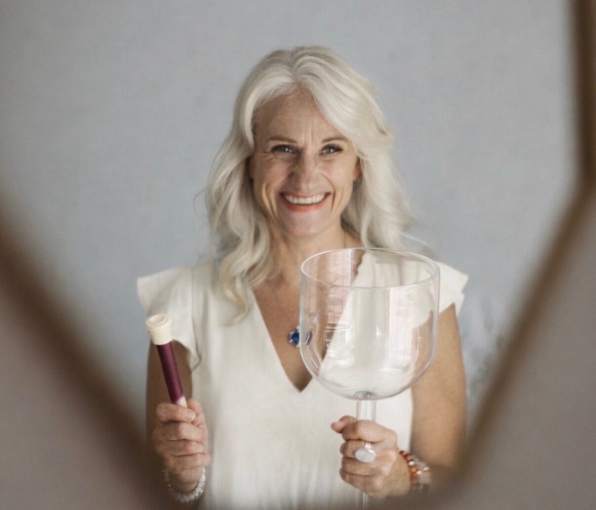 Helen Armstrong holding a crystal singing bowl.